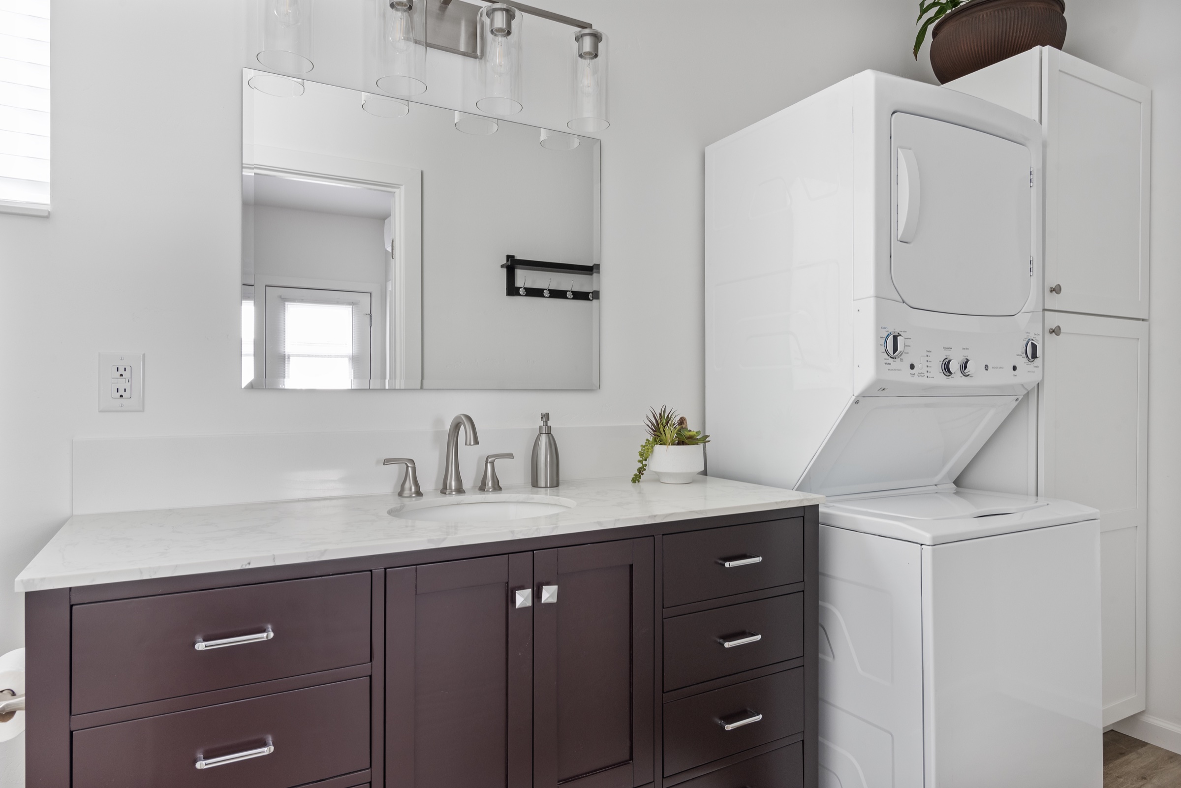 ADU bathroom with integrated laundry storage