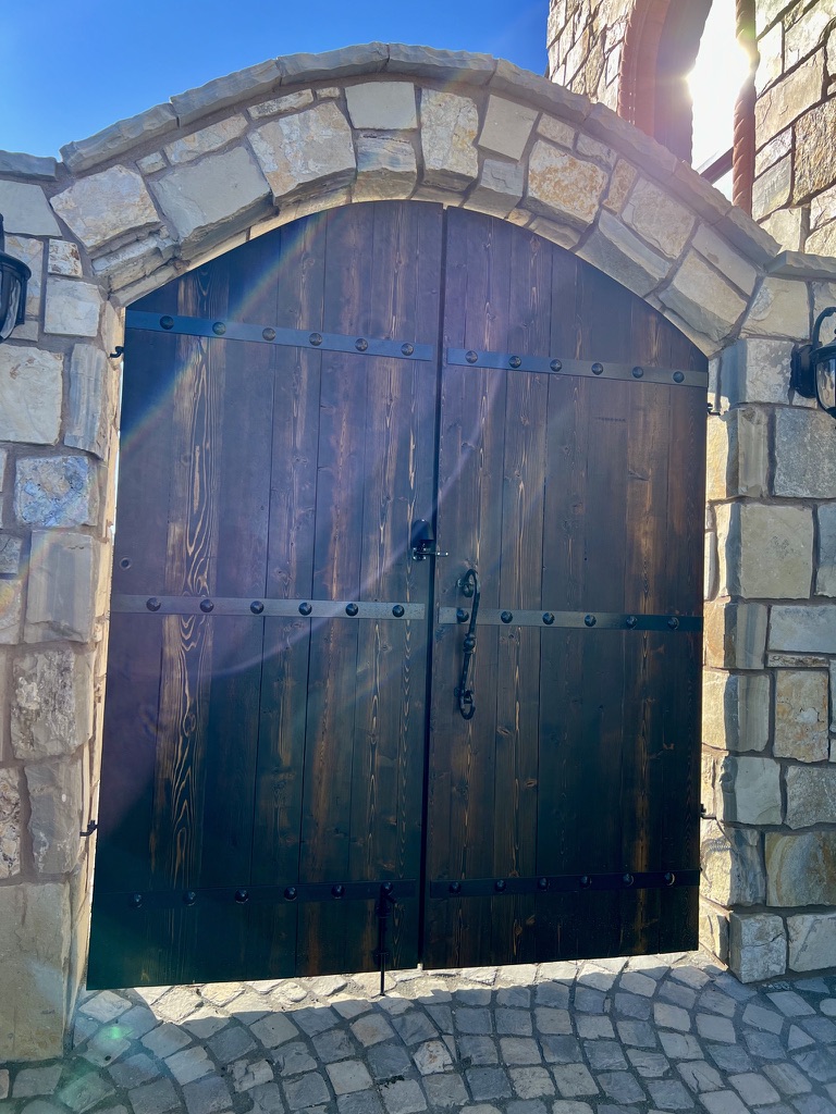 Handcrafted wood entry gate with decorative hardware