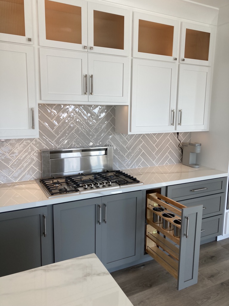 Custom range wall with detailed cabinetry and tile backsplash