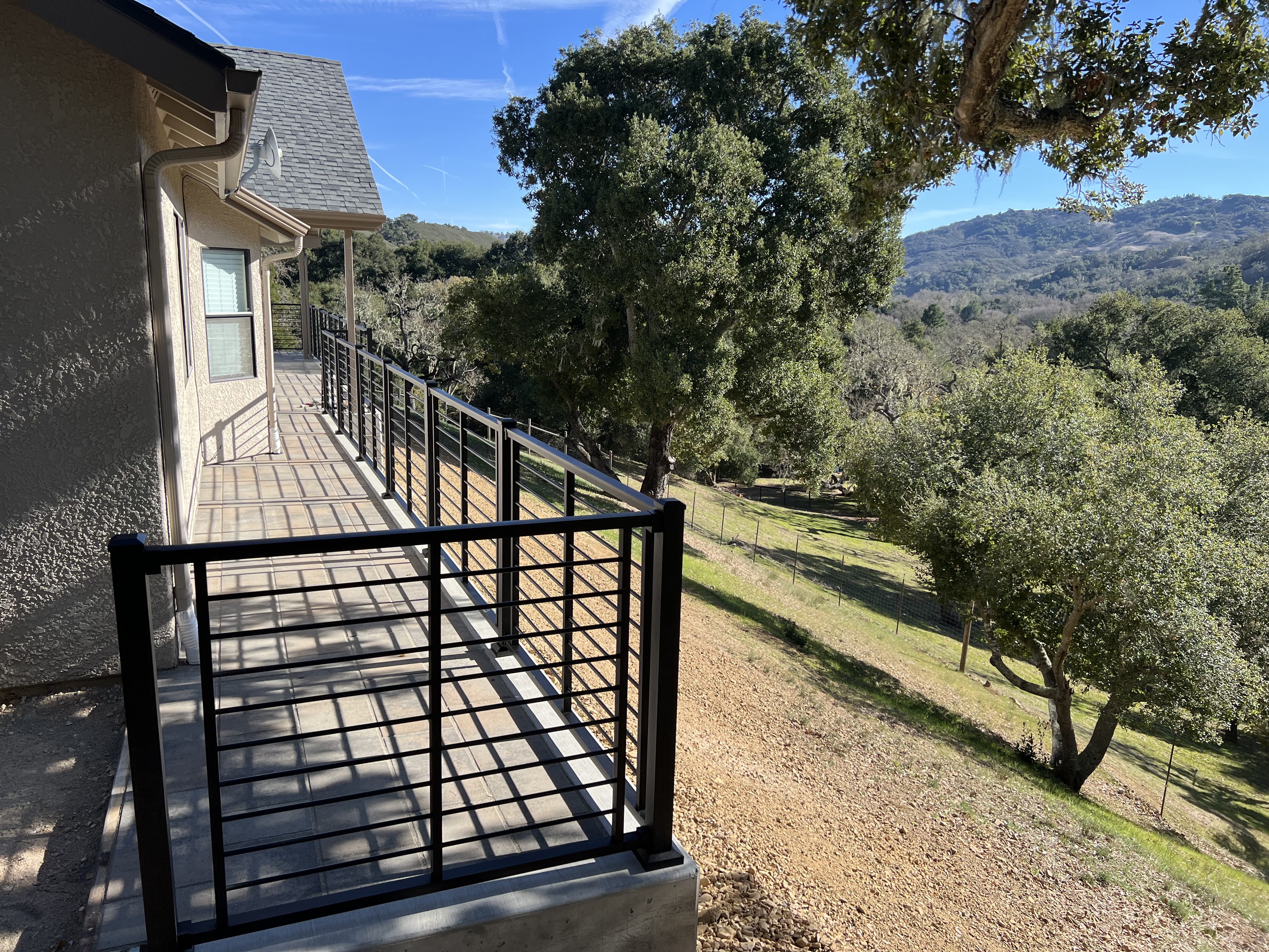 Custom exterior deck railing with hillside view